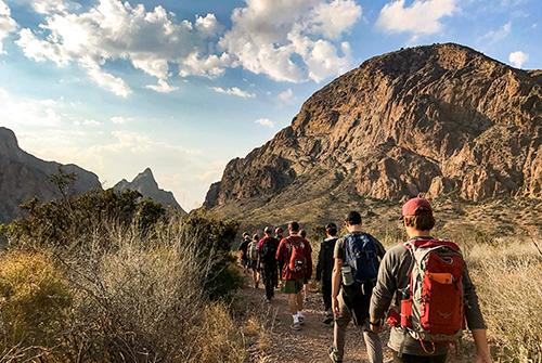 Group of Aggies hiking with Outdoor Adventures