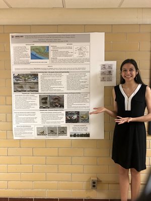 Achorn presenting a poster of her research